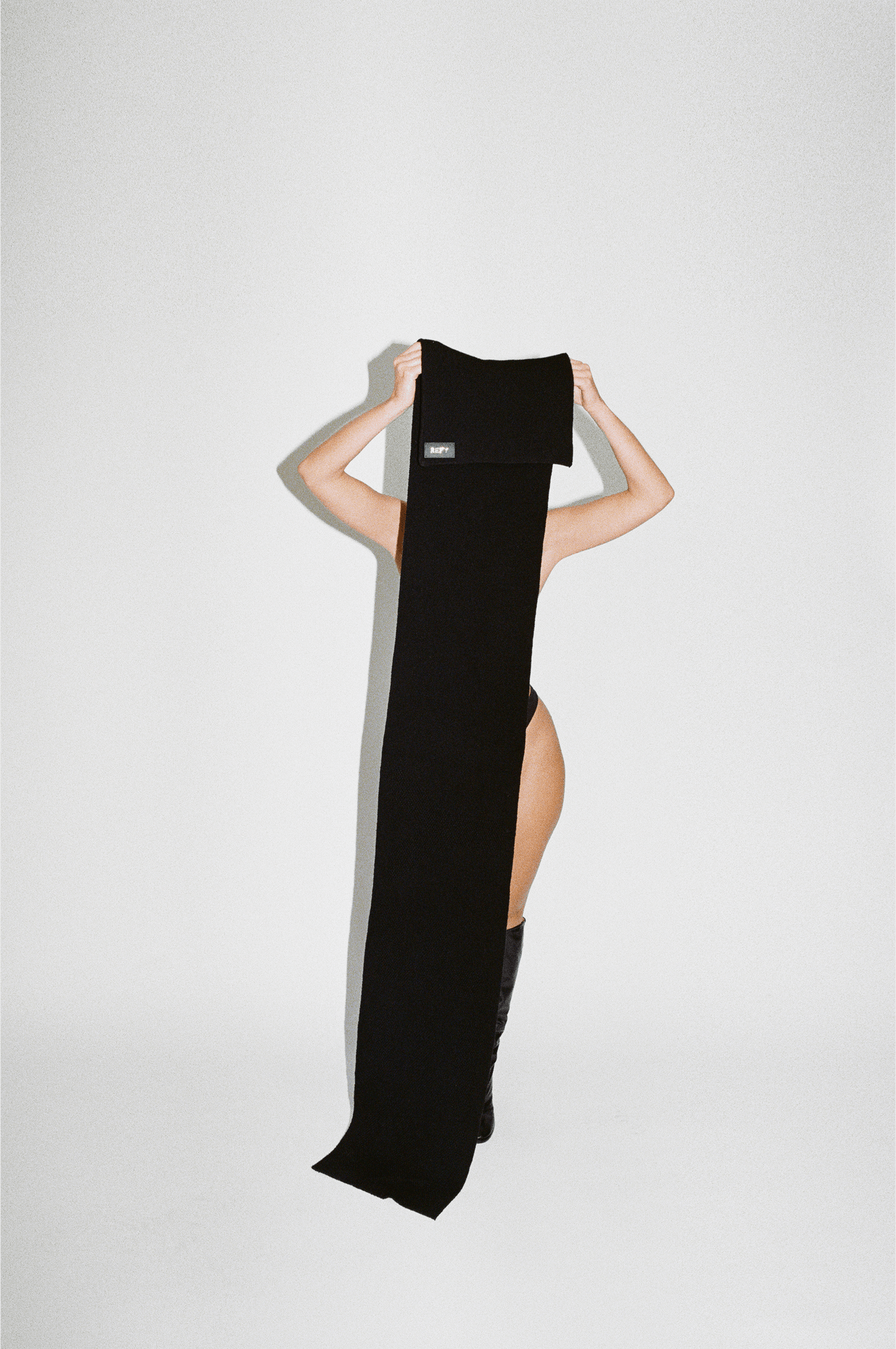 FRONT IMAGE OF REFY WOOL SCARF IN BLACK WITH MODEL